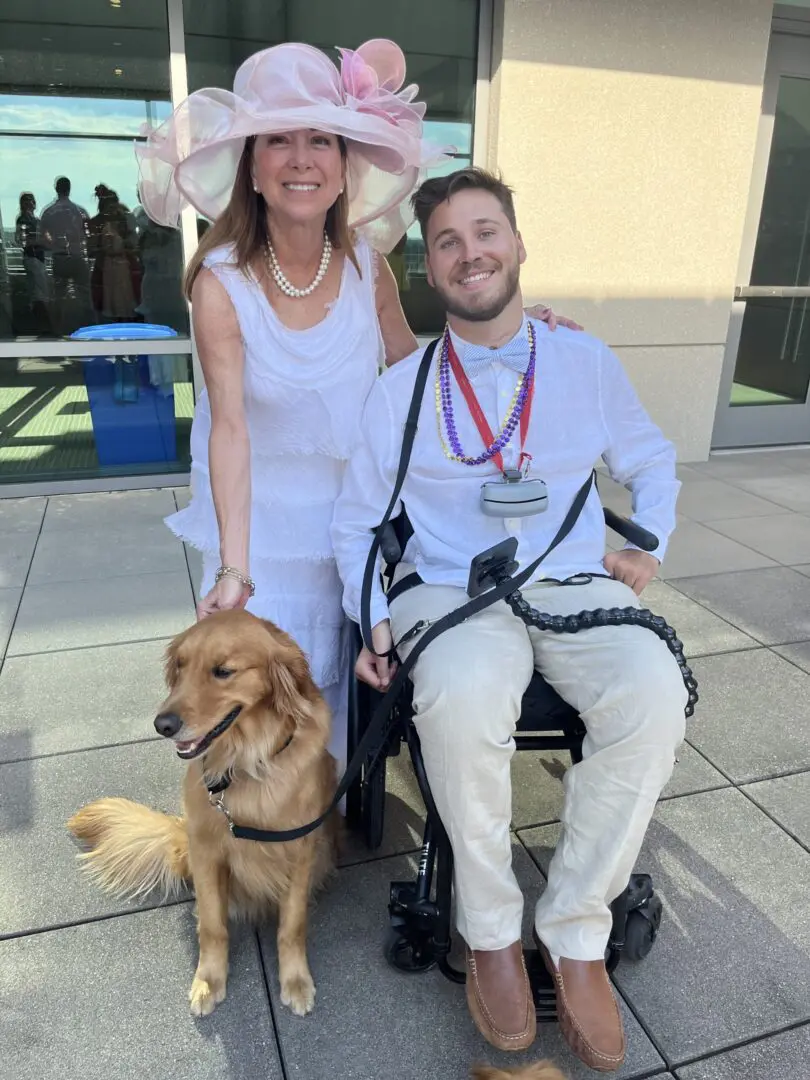 A man and woman in white dress with dog.